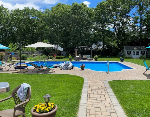 a view of a swimming pool with lounge chairs in the patio