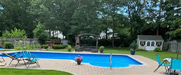 a view of a swimming pool with seating space
