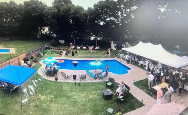 a view of a house with swimming pool and sitting area