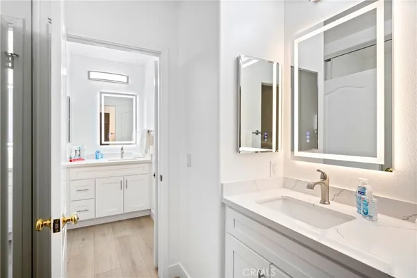 a bathroom with a sink vanity and mirror