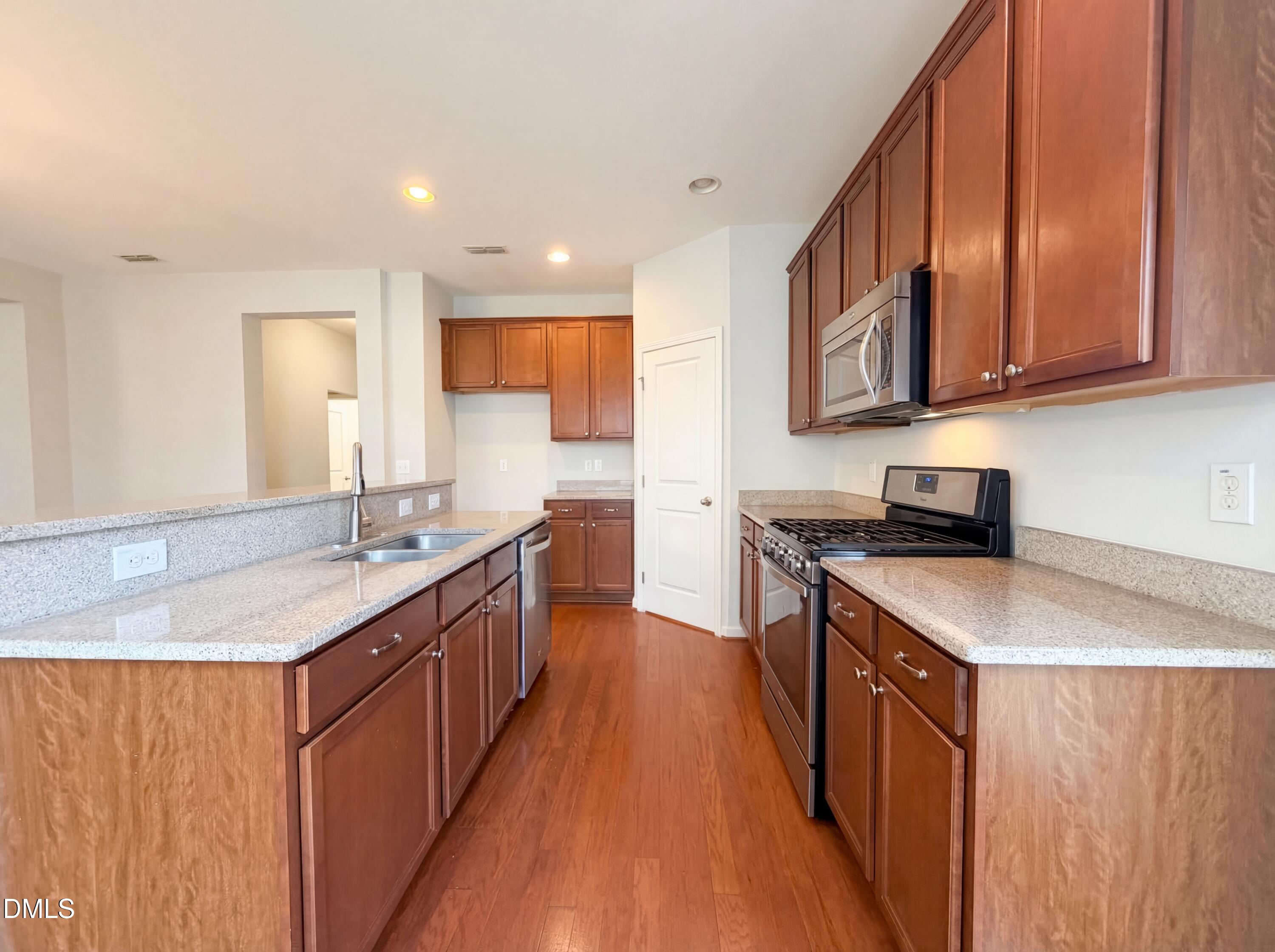 3933 Massey Run Raleigh, NC 27616 - Photo 2 of 19 a kitchen with stainless steel appliances granite countertop a sink stove and refrigerator