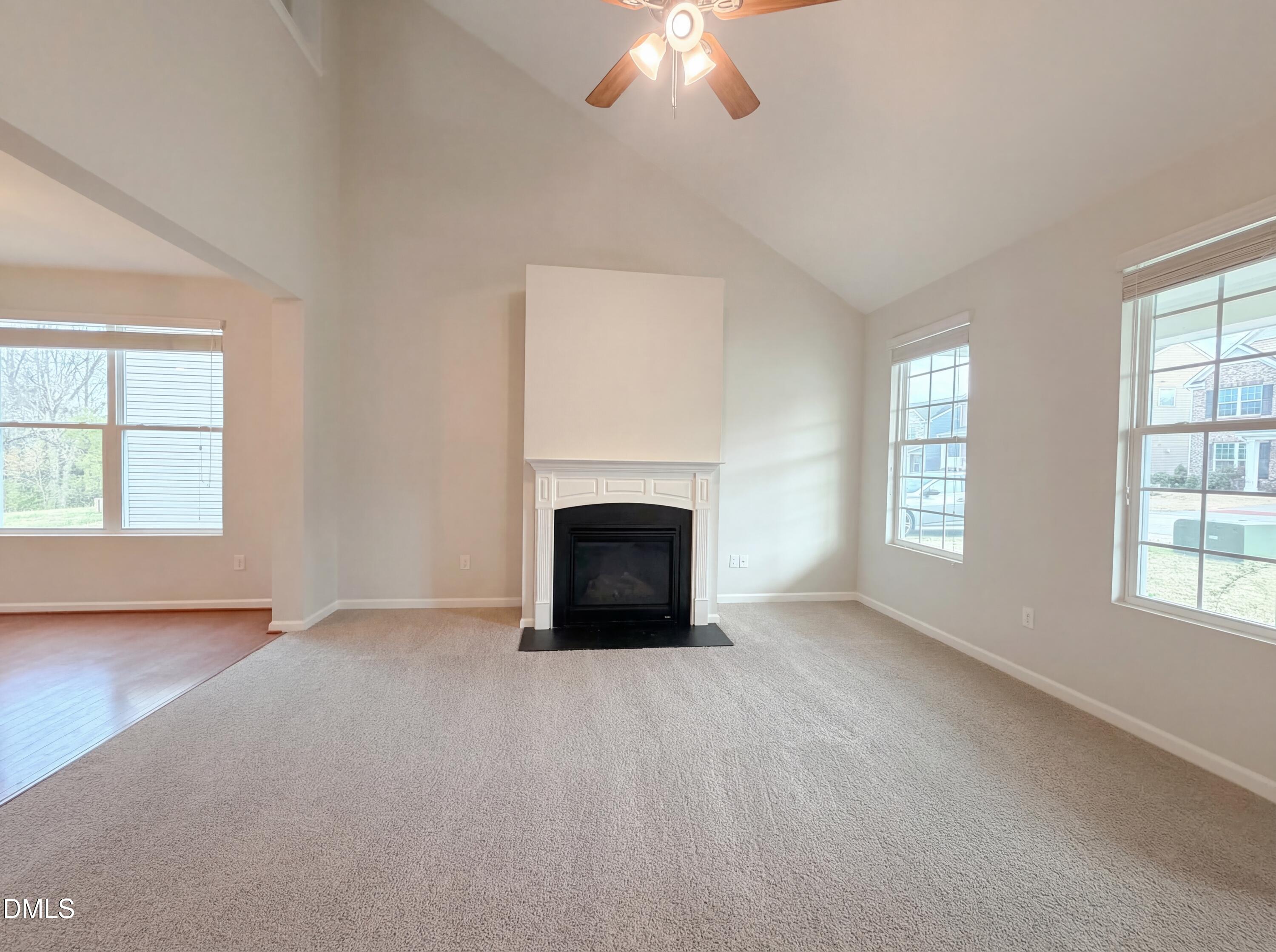 3933 Massey Run Raleigh, NC 27616 - Photo 3 of 19 an empty room with windows and fireplace