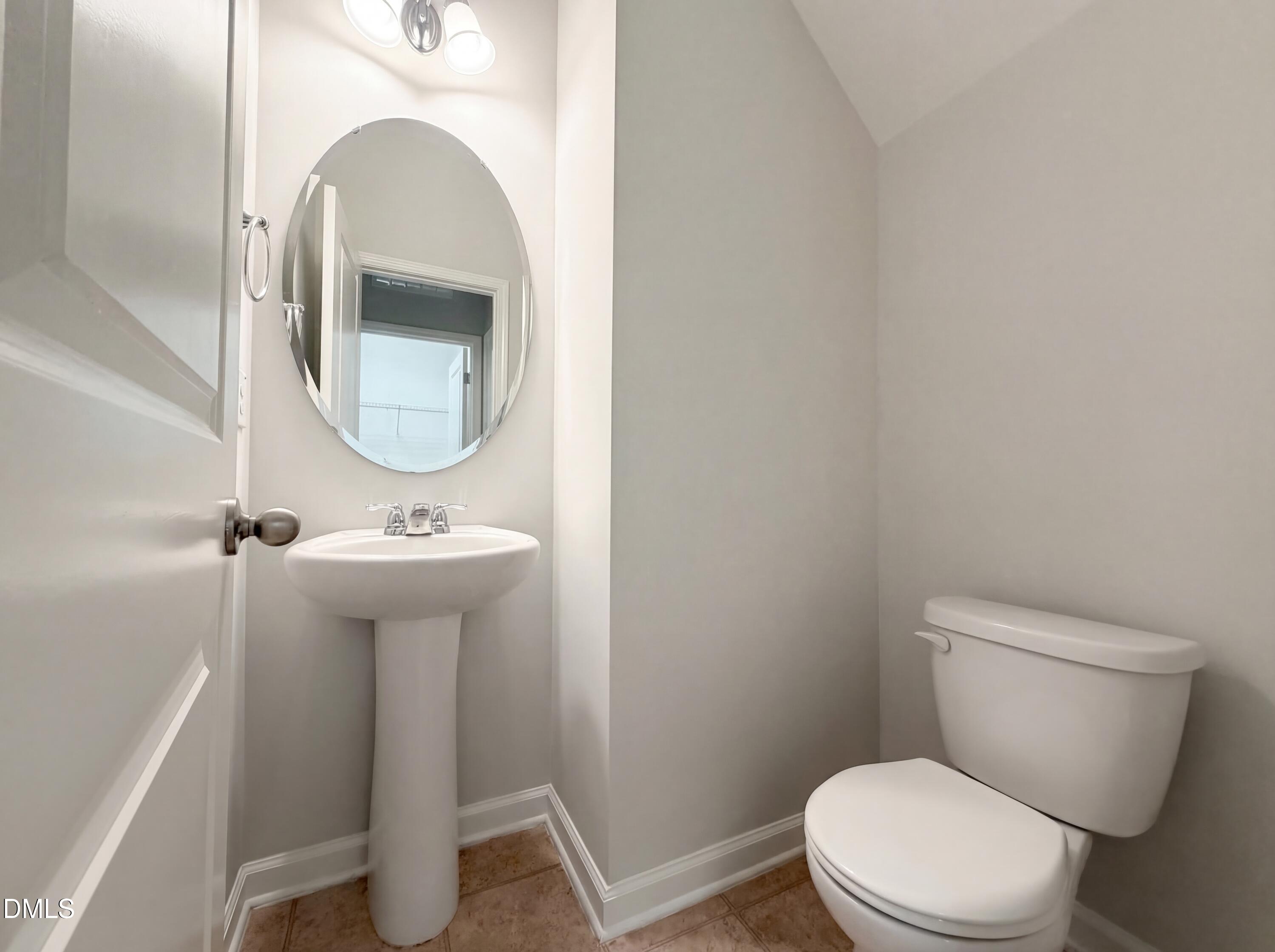 3933 Massey Run Raleigh, NC 27616 - Photo 6 of 19 a bathroom with a toilet sink and mirror