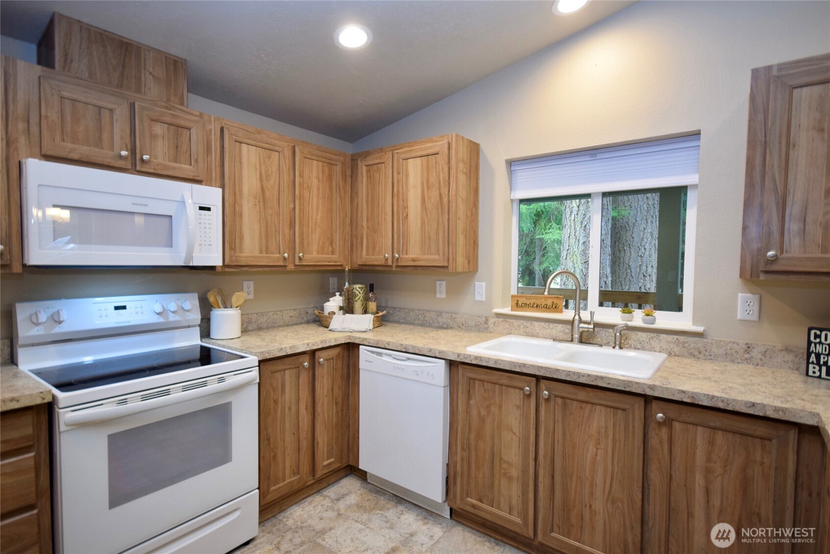 375 Dungeness Meadows Sequim, WA 98382 - Photo 11 of 27 a kitchen with a sink stove and cabinets