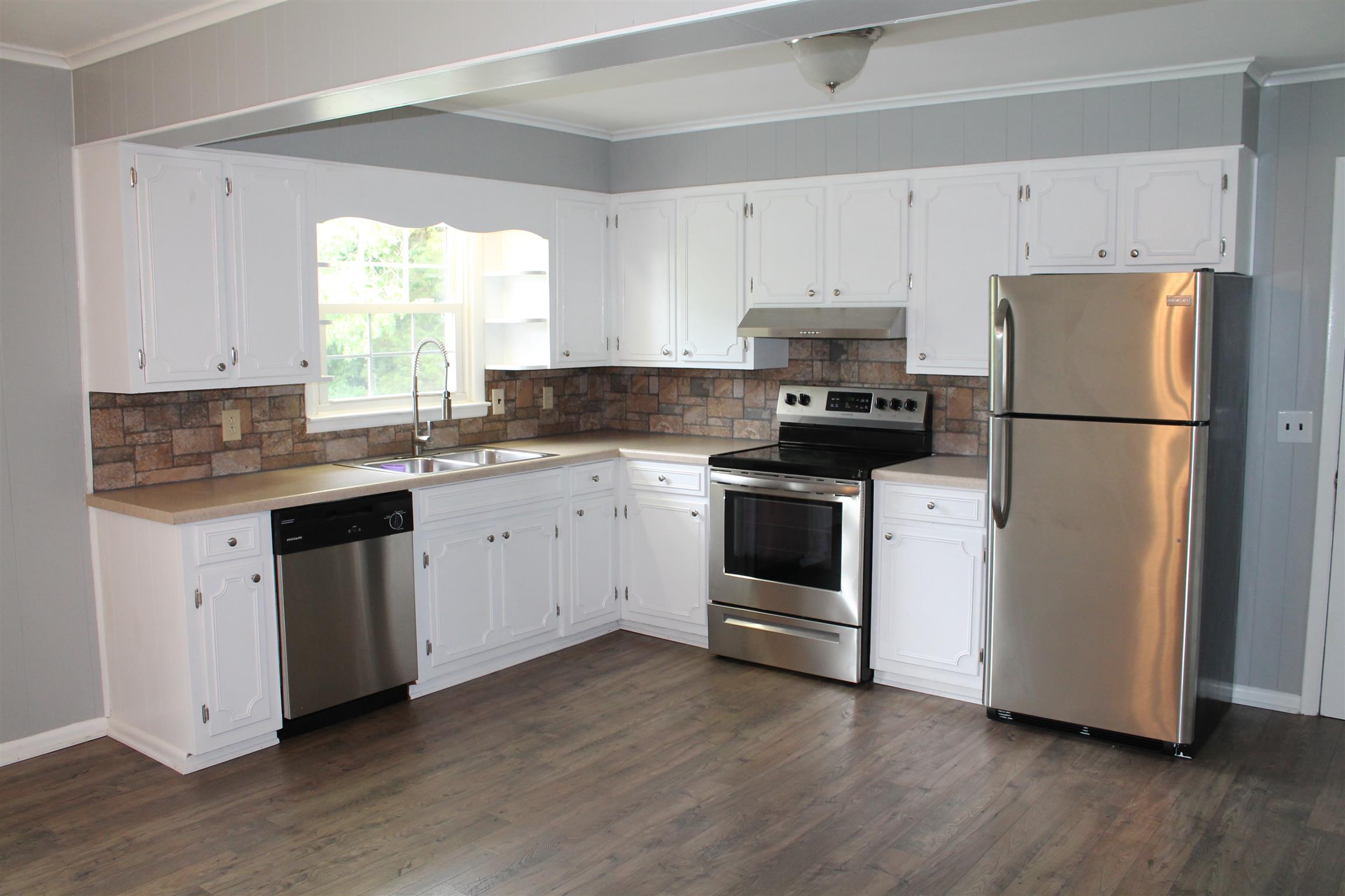 731 Lafayette Road Red Boiling Springs, TN 37150 - Photo 5 of 13 a kitchen with appliances a sink cabinets and a window