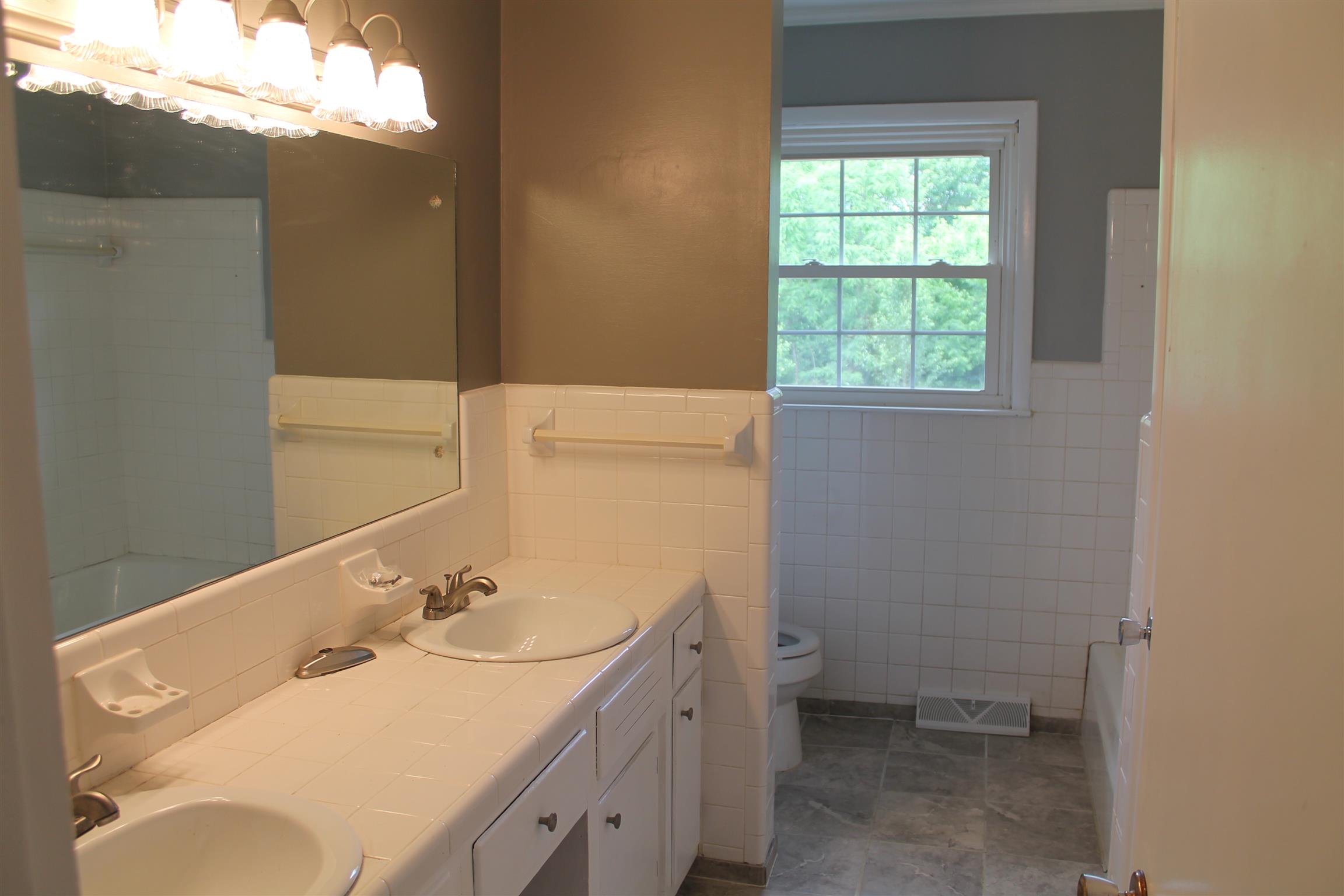 731 Lafayette Road Red Boiling Springs, TN 37150 - Photo 9 of 13 a bathroom with a sink toilet vanity and window