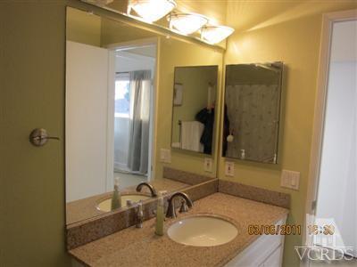 436 Reed Way Port Hueneme, CA 93041 - Photo 13 of 19 a bathroom with a granite countertop sink and a mirror