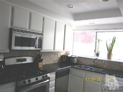 436 Reed Way Port Hueneme, CA 93041 - Photo 3 of 19 a kitchen with stainless steel appliances granite countertop a sink a stove and a microwave