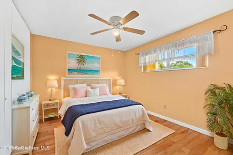 a bedroom with a bed and a potted plant