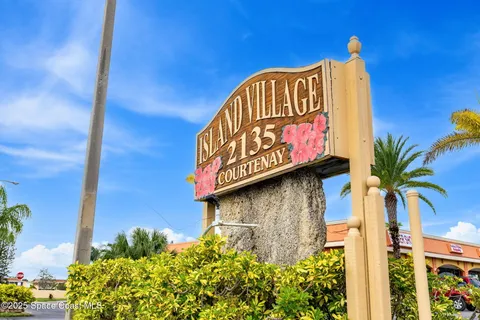 a street sign on a wall next to a building