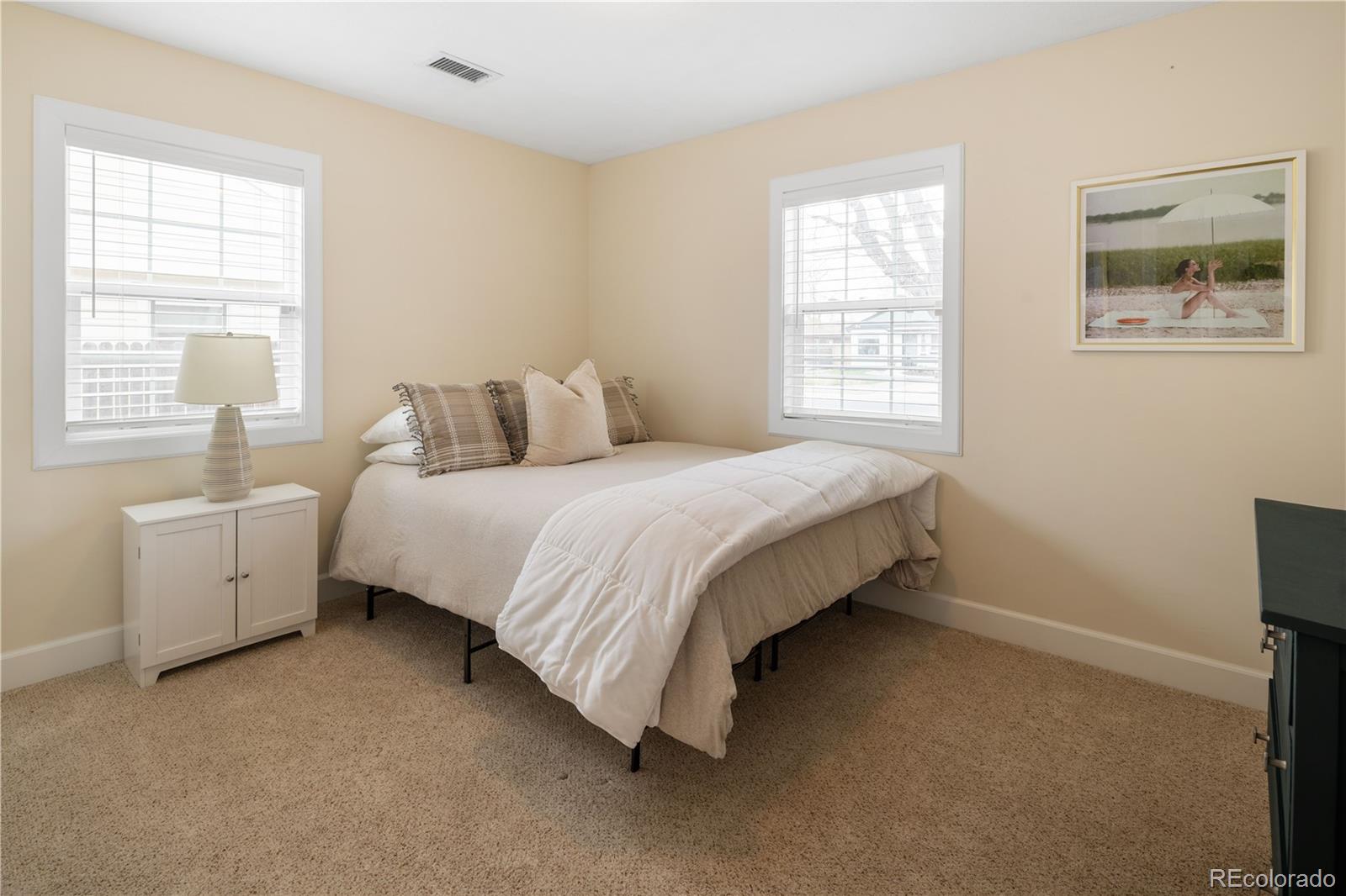 2242 North Lamar Street Edgewater, CO 80214 - Photo 18 of 27 a bedroom with a bed and a window