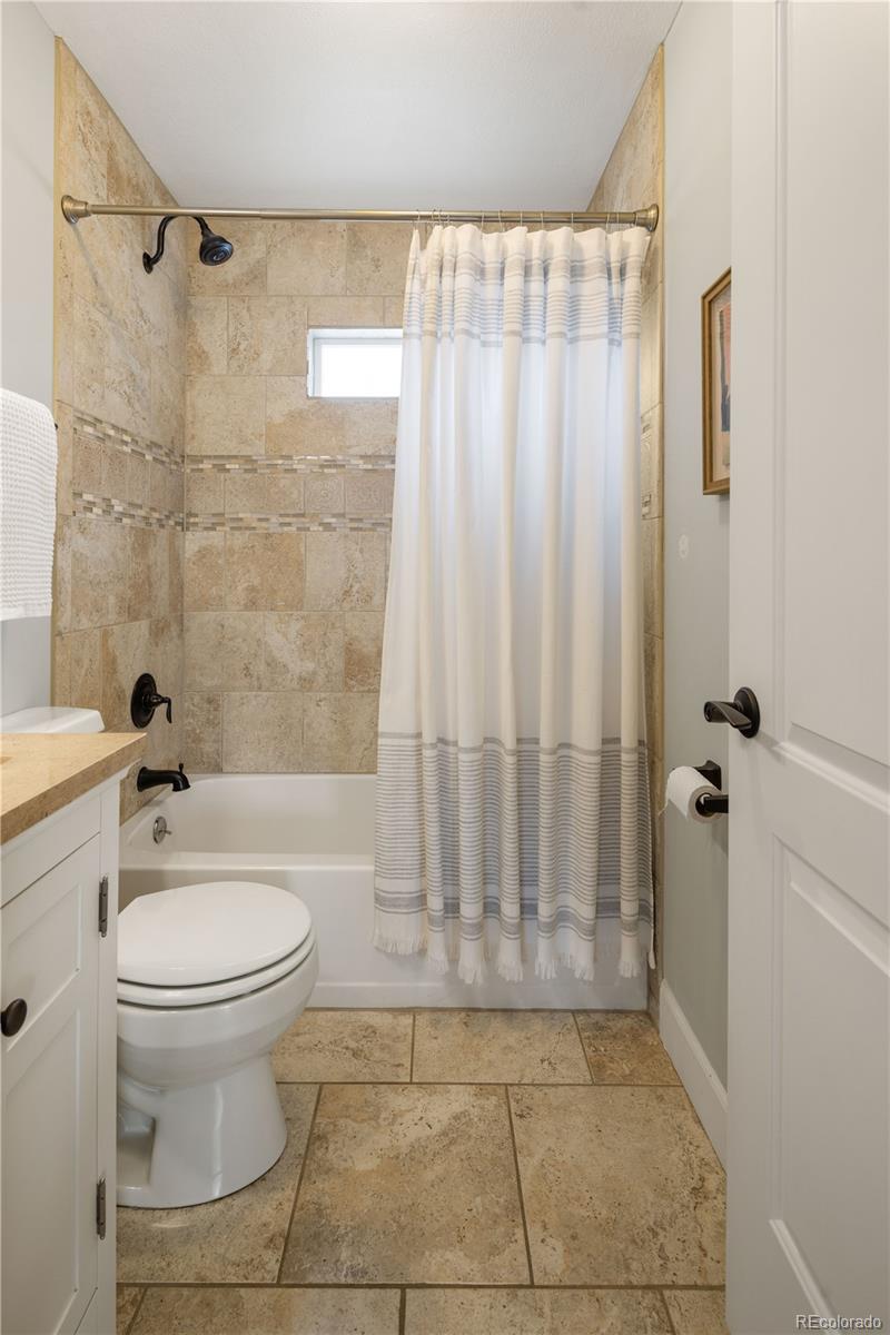 2242 North Lamar Street Edgewater, CO 80214 - Photo 21 of 27 a bathroom with a toilet and a shower