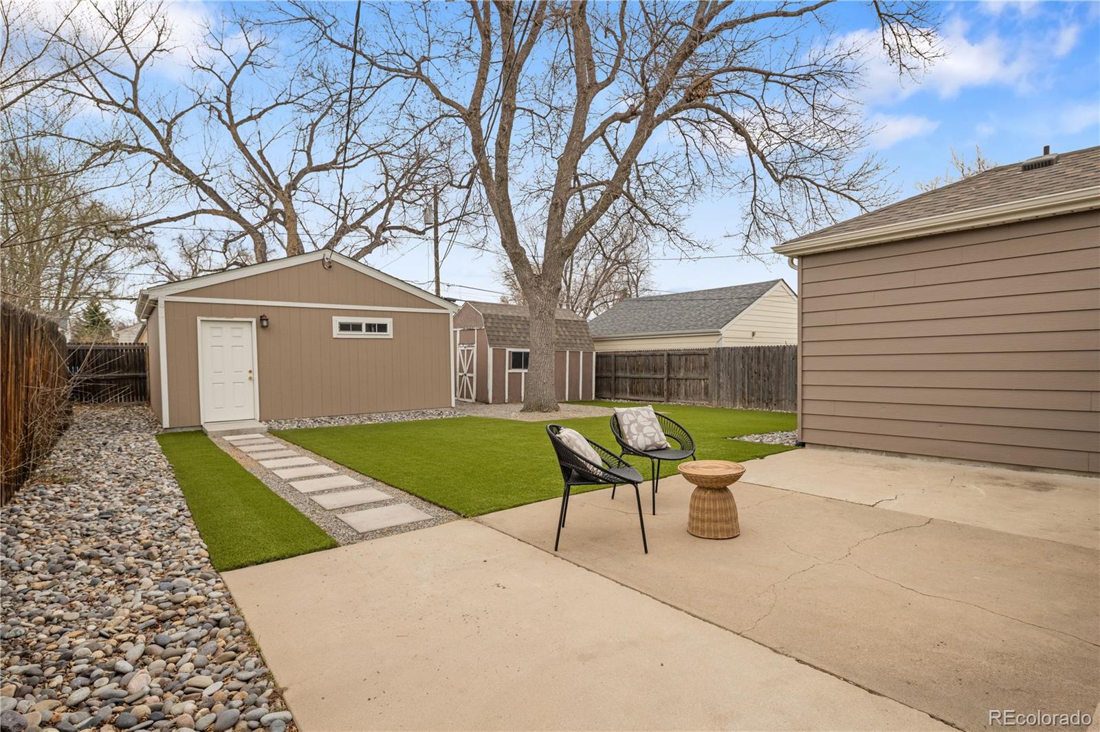 2242 North Lamar Street Edgewater, CO 80214 - Photo 23 of 27 a backyard of a house with table and chairs under an umbrella