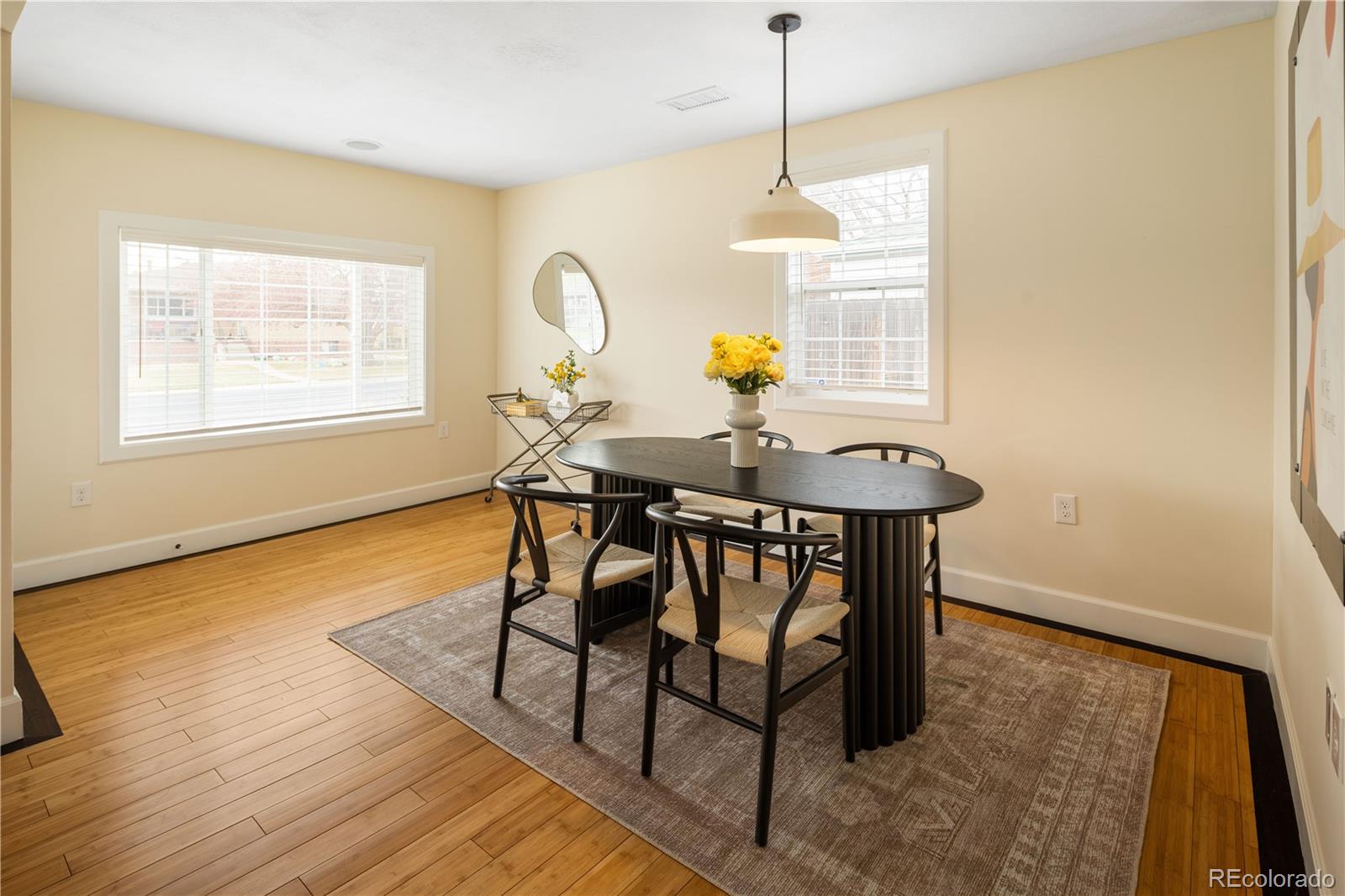 2242 North Lamar Street Edgewater, CO 80214 - Photo 8 of 27 a view of a dining room and livingroom with furniture wooden floor a chandelier