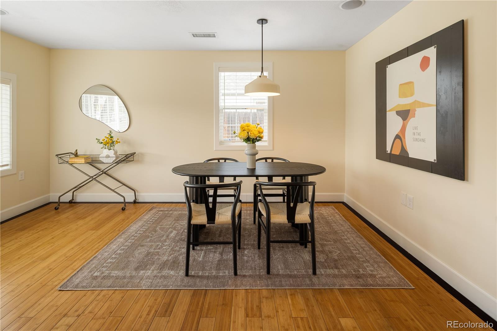 2242 North Lamar Street Edgewater, CO 80214 - Photo 9 of 27 a dining room with wooden floor a glass table and chairs