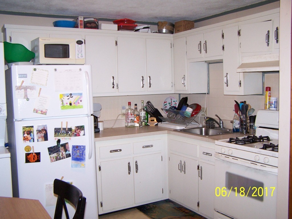 5 Kenmar Drive, Unit 18 Billerica, MA 01821 - Photo 3 of 10 a kitchen with cabinets appliances and wooden floor