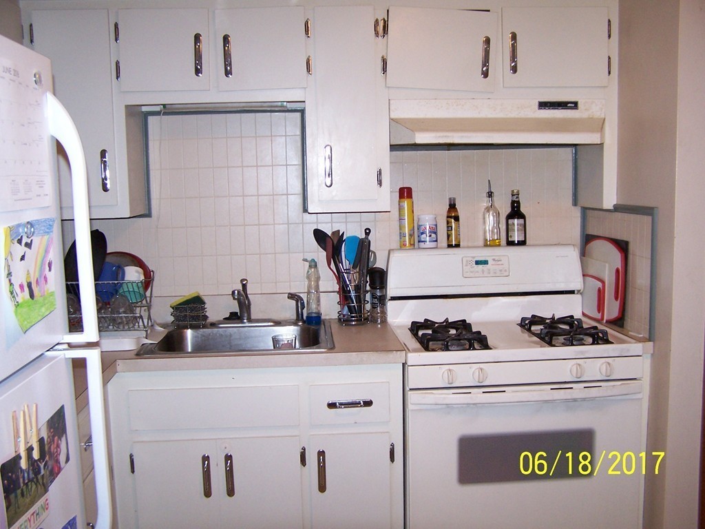 5 Kenmar Drive, Unit 18 Billerica, MA 01821 - Photo 5 of 10 a kitchen with appliances a stove and cabinets