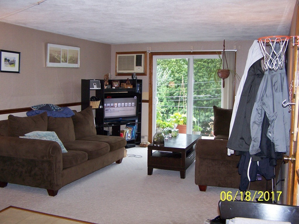 5 Kenmar Drive, Unit 18 Billerica, MA 01821 - Photo 6 of 10 a living room with furniture and a flat screen tv