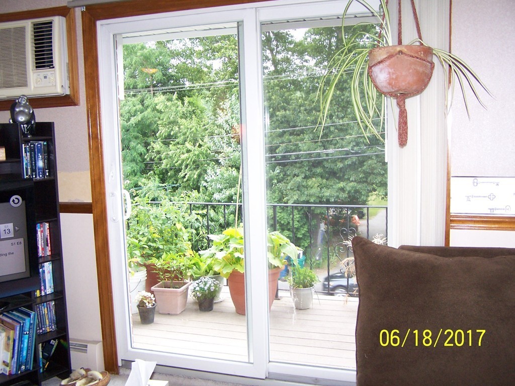 5 Kenmar Drive, Unit 18 Billerica, MA 01821 - Photo 7 of 10 a living room filled with furniture and a potted plant