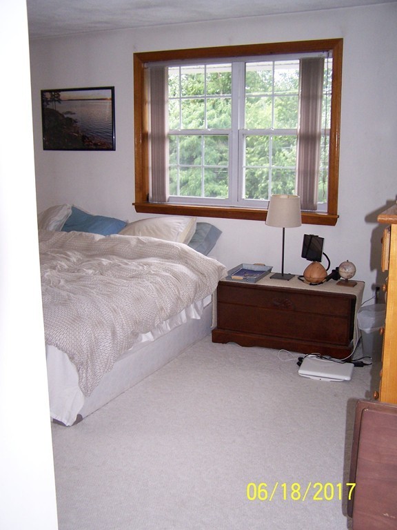 5 Kenmar Drive, Unit 18 Billerica, MA 01821 - Photo 9 of 10 a bedroom with a bed and a window