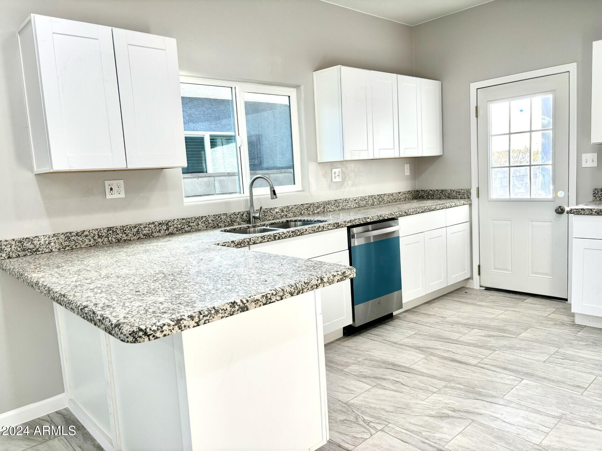 3440 Camino Del Rancho Douglas, AZ 85607 - Photo 2 of 14 a kitchen with granite countertop sink and cabinets
