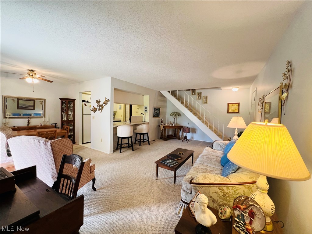 4940 Friar Road, Unit B Stow, OH 44224 - Photo 2 of 33 Living room with light colored carpet, ceiling fan, and a textured ceiling