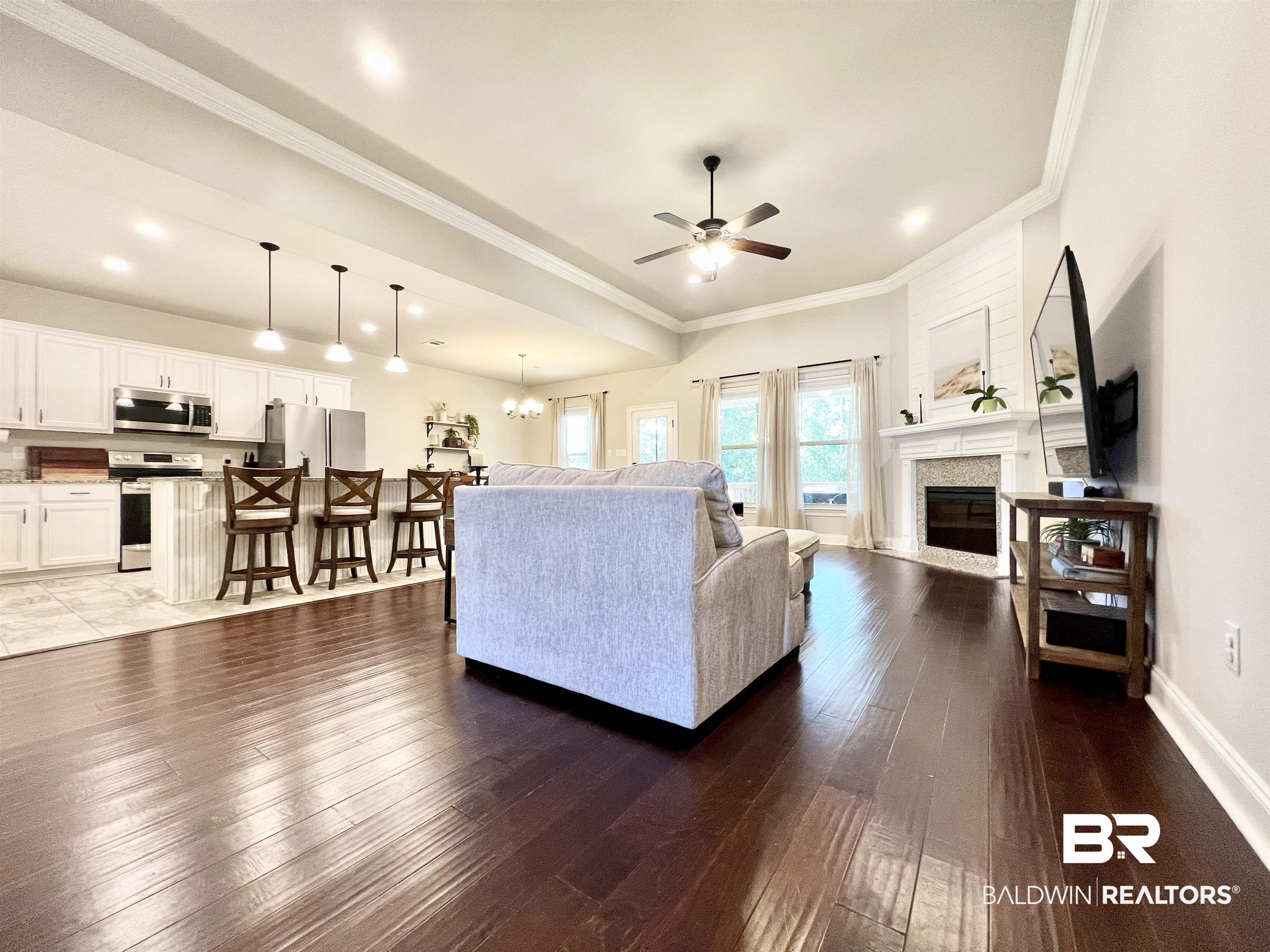 32290 Calder Court Daphne, AL 36527 - Photo 10 of 59 Living room featuring ornamental molding, dark hardwood / wood-style flooring, and ceiling fan with notable chandelier