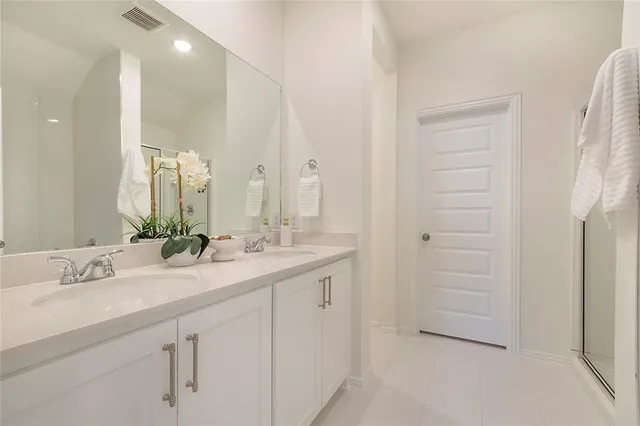 a bathroom with a double vanity sink and a mirror