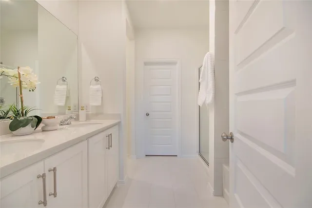 a bathroom with a double vanity sink and mirror