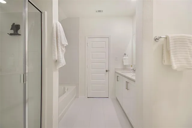 a bathroom with a shower and a sink