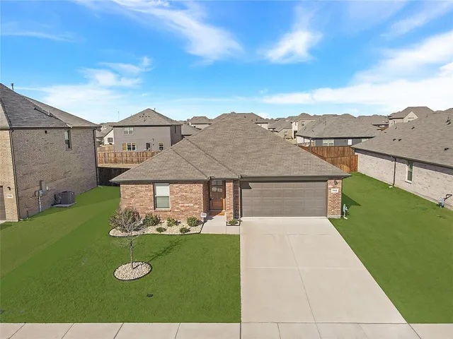 a view of a big house with a big yard