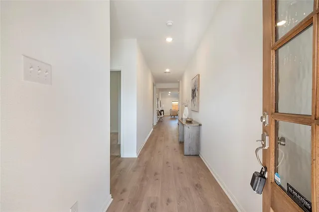 a view of a room with wooden floor