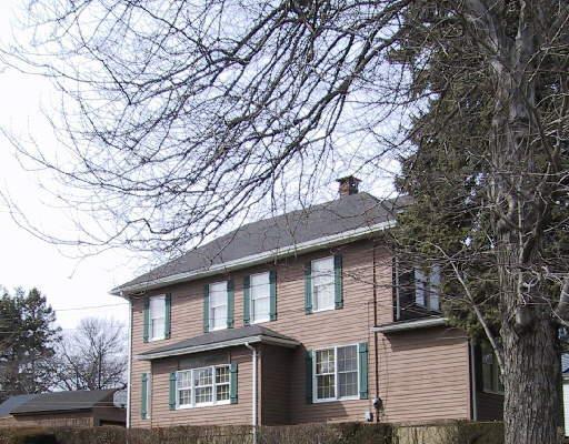 949 Huntington Road Stratford, CT 06614 - Photo 1 of 1 a front view of a house with large trees