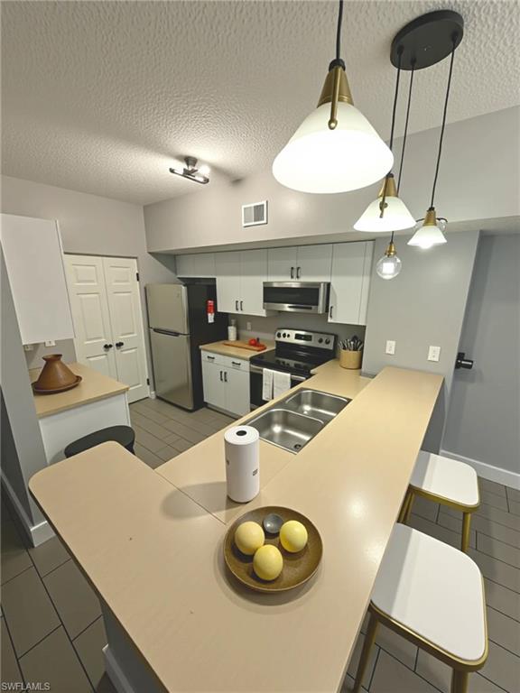 1820 Florida Club Circle, Unit 2201 Naples, FL 34112 - Photo 2 of 9 a kitchen with a table chairs and a stove