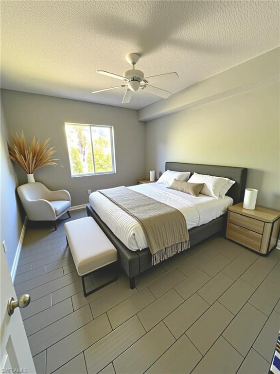 1820 Florida Club Circle, Unit 2201 Naples, FL 34112 - Photo 3 of 9 a bedroom with a bed and a chandelier