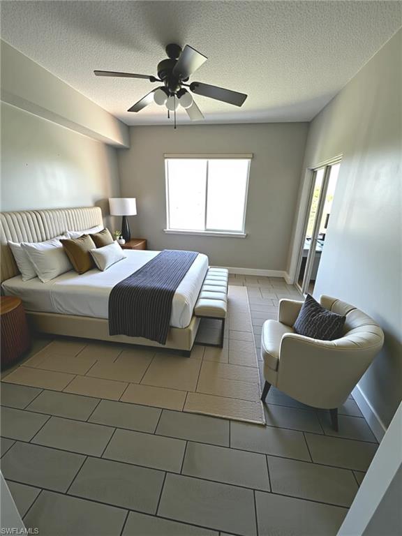 1820 Florida Club Circle, Unit 2201 Naples, FL 34112 - Photo 4 of 9 a bedroom with a bed and a chandelier