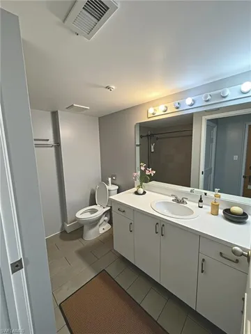 a bathroom with a double vanity sink and mirror
