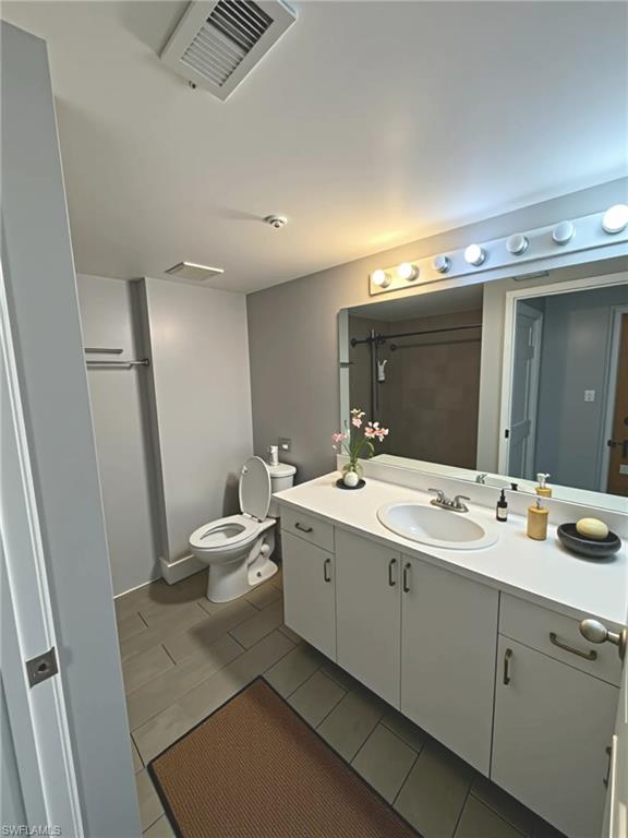 1820 Florida Club Circle, Unit 2201 Naples, FL 34112 - Photo 6 of 9 a bathroom with a double vanity sink and mirror