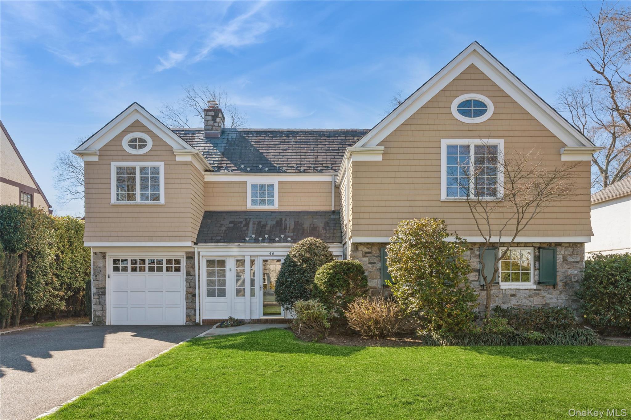 a front view of house with yard and green space