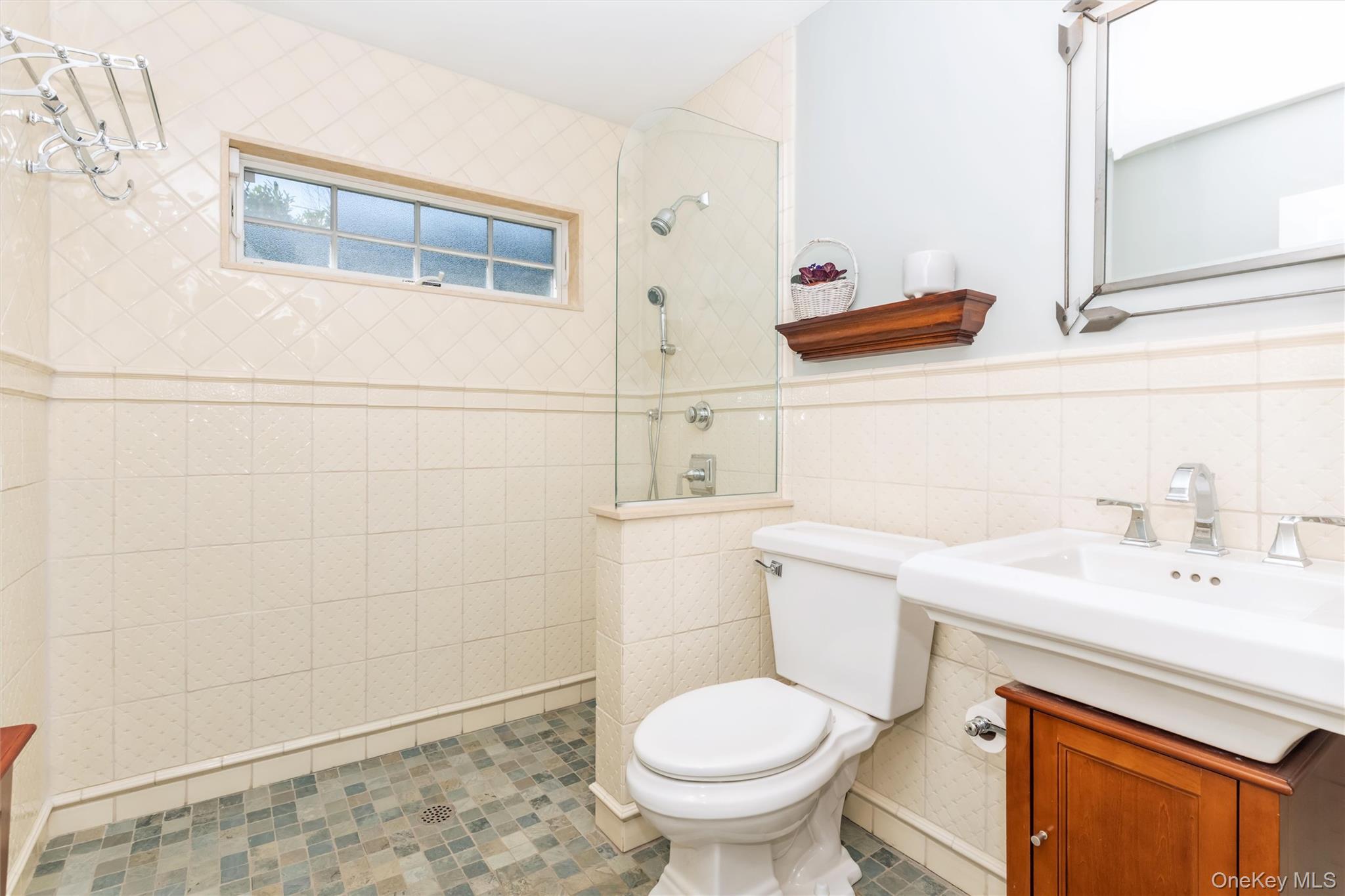 46 Wyatt Road Garden City, NY 11530 - Photo 18 of 32 a bathroom with a sink a toilet and shower