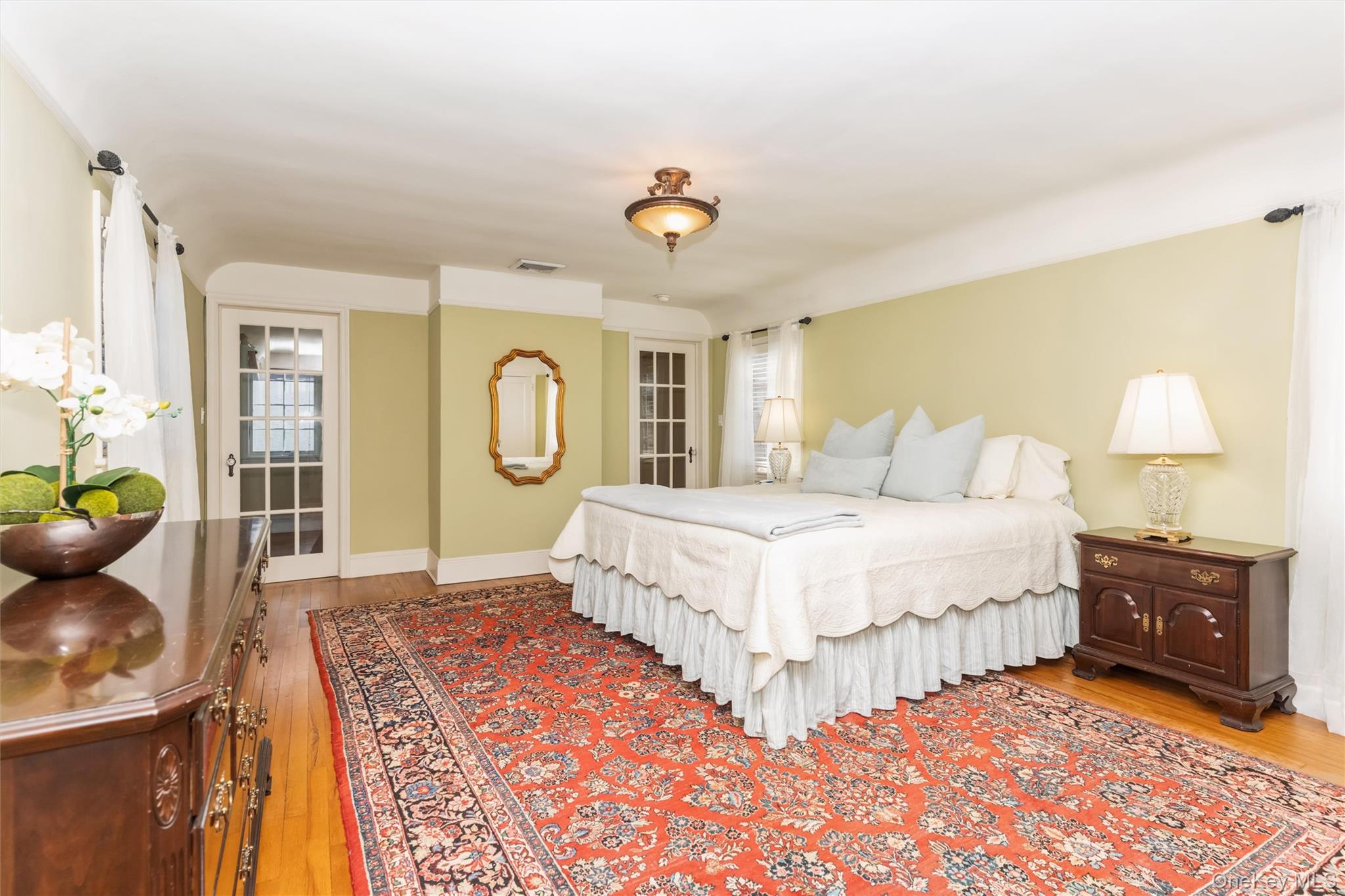 46 Wyatt Road Garden City, NY 11530 - Photo 20 of 32 a bedroom with a bed dresser and a window