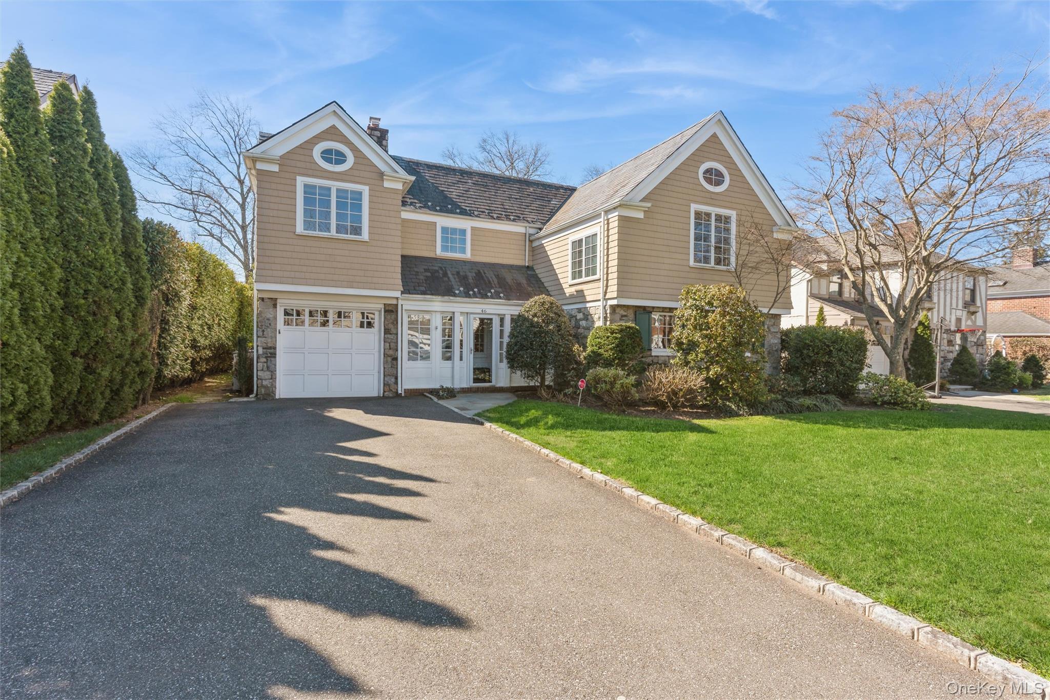 46 Wyatt Road Garden City, NY 11530 - Photo 2 of 32 a front view of a house with garden