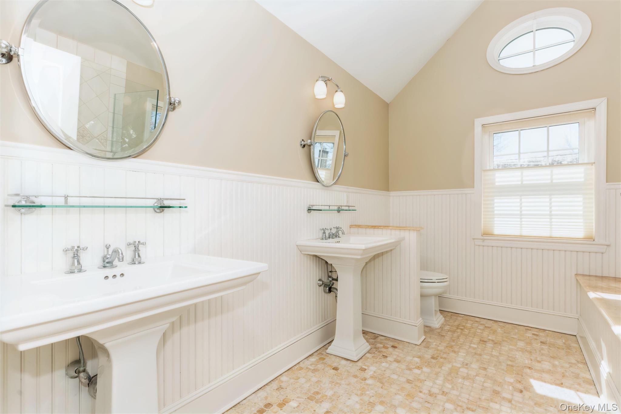 46 Wyatt Road Garden City, NY 11530 - Photo 22 of 32 a bathroom with a sink a toilet and a mirror