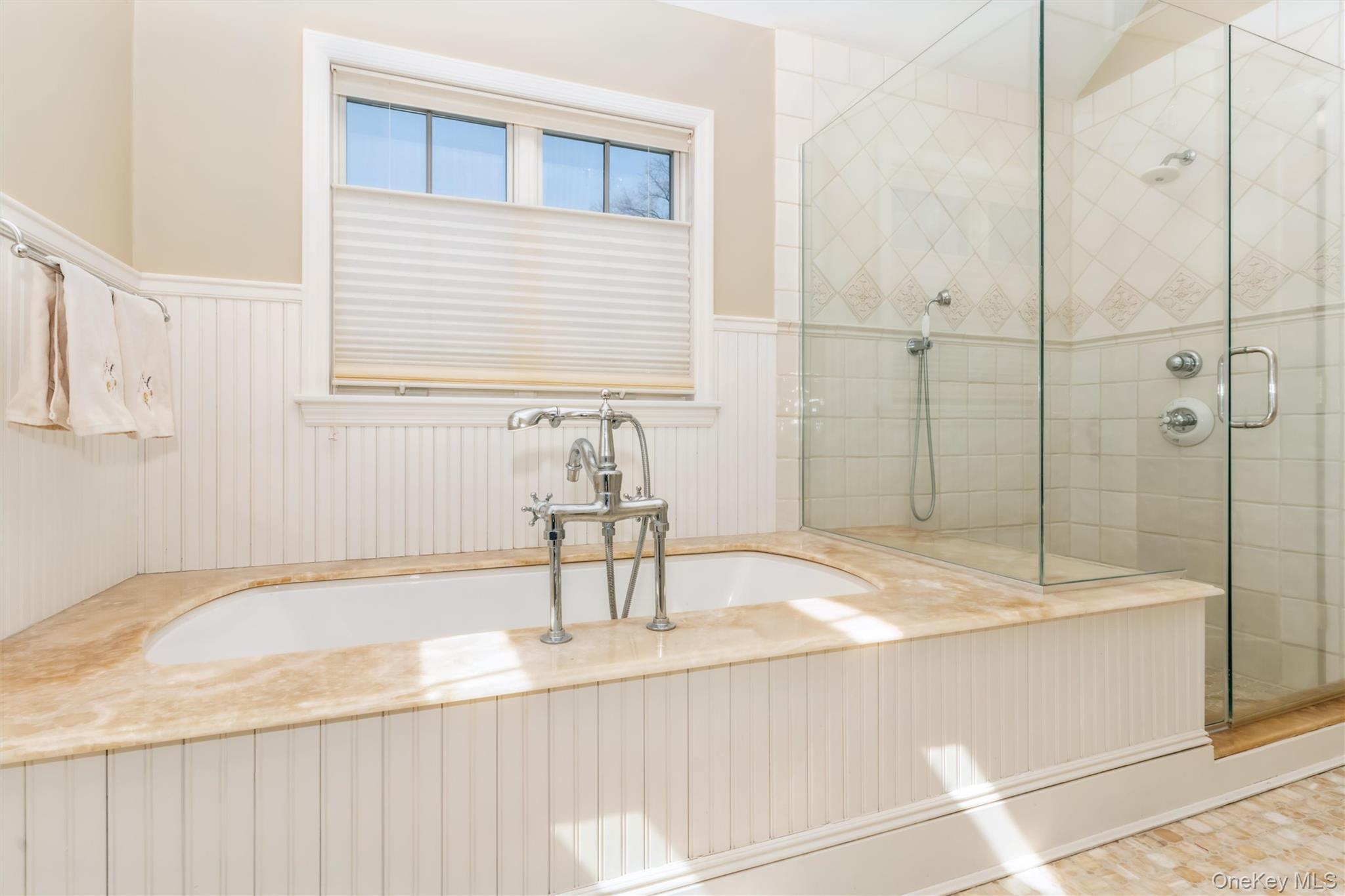 46 Wyatt Road Garden City, NY 11530 - Photo 23 of 32 a bathroom with a granite countertop sink and a bathtub
