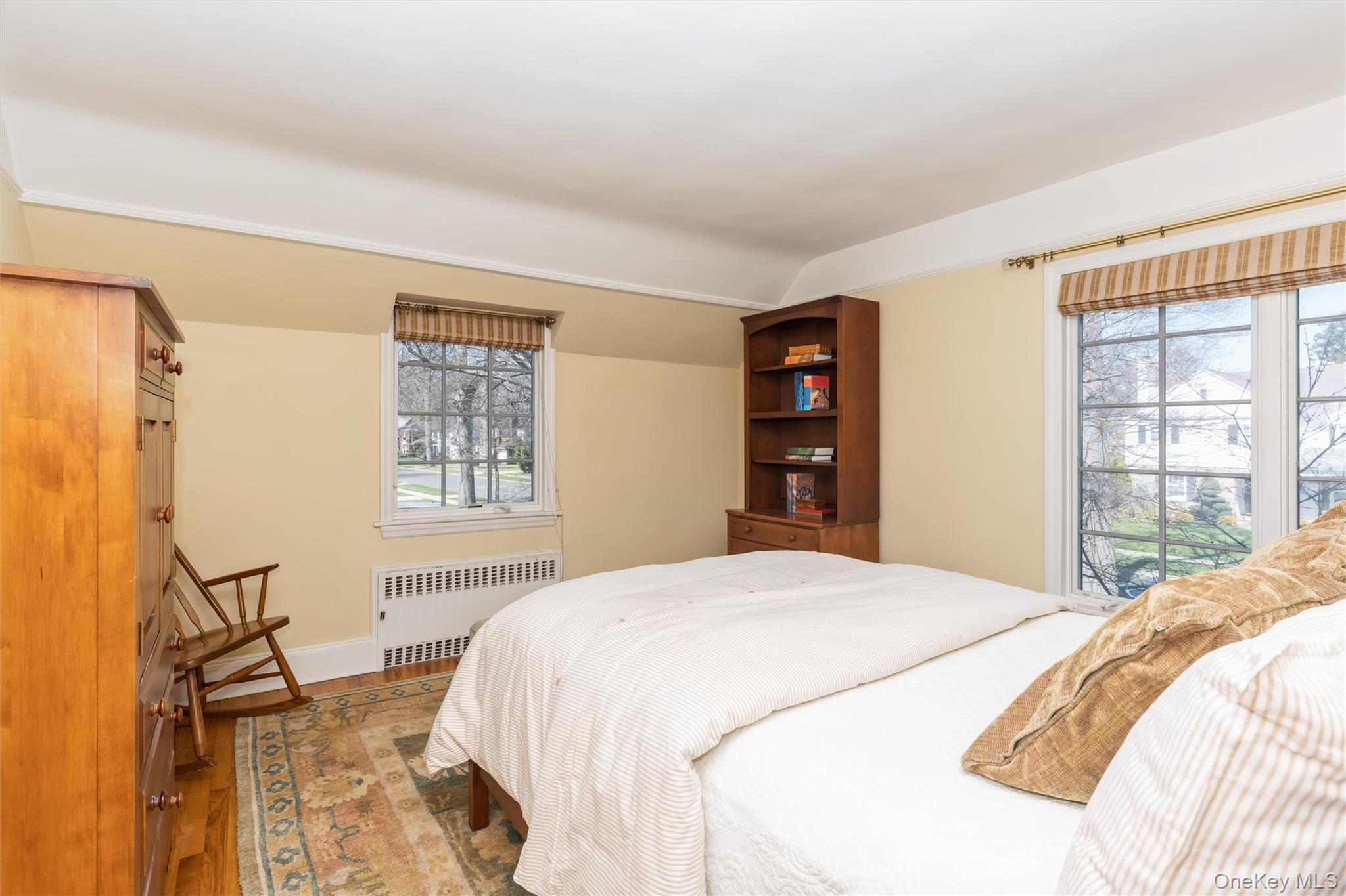 46 Wyatt Road Garden City, NY 11530 - Photo 26 of 32 a bedroom with a large bed and a window