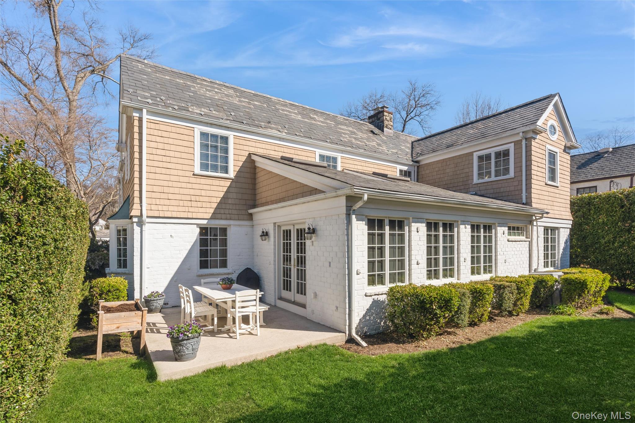 46 Wyatt Road Garden City, NY 11530 - Photo 29 of 32 a view of a house with a yard and sitting area
