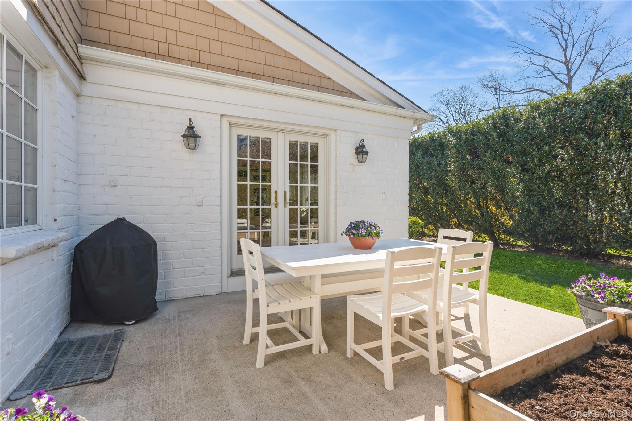 46 Wyatt Road Garden City, NY 11530 - Photo 30 of 32 a view of a patio with table and chairs and potted plants