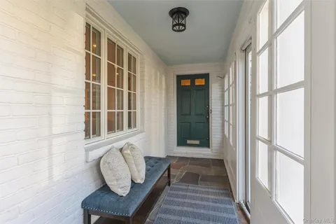 a view of front door of house with stairs