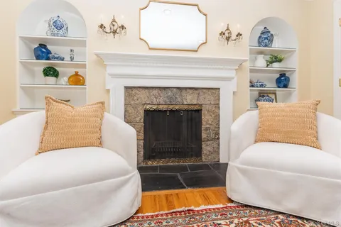 a living room with a couch a rug and a fireplace