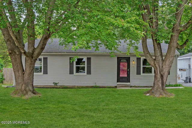 a front view of house with yard and green space